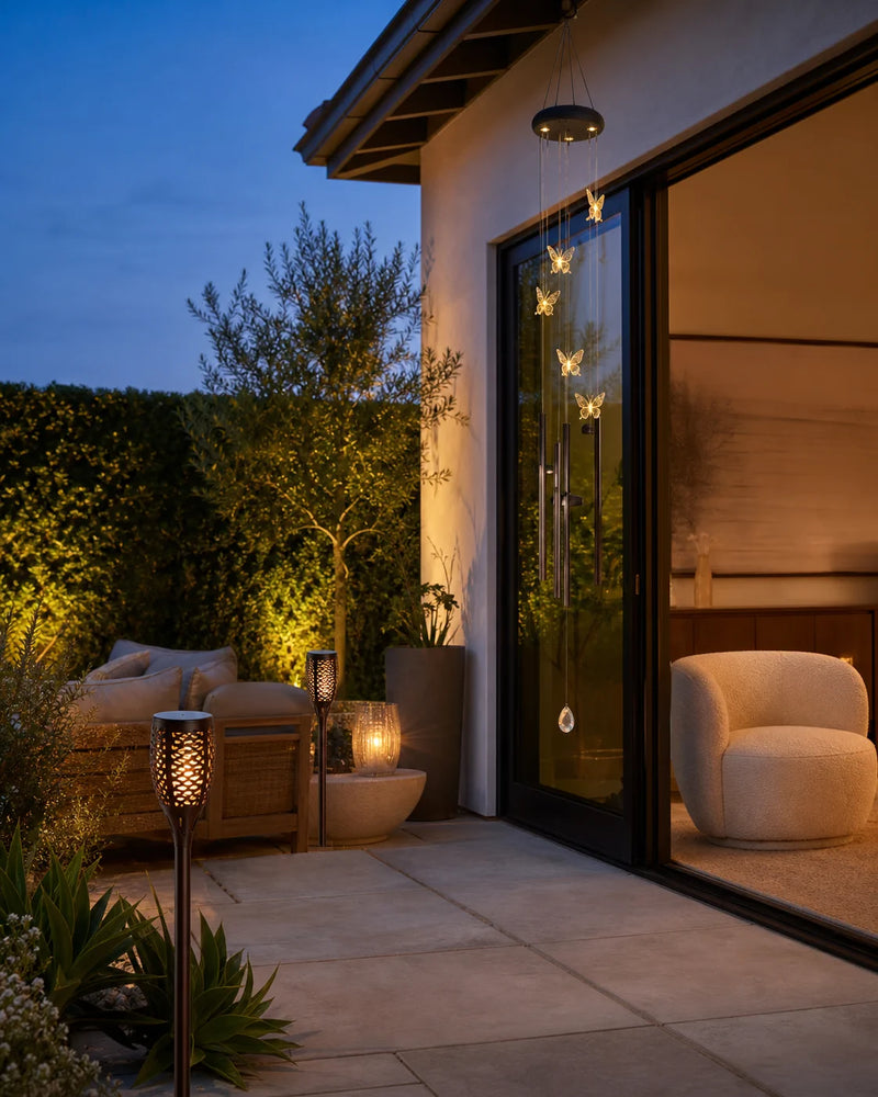 edeco solar butterfly wind chimes and torch lights on a California patio at dusk