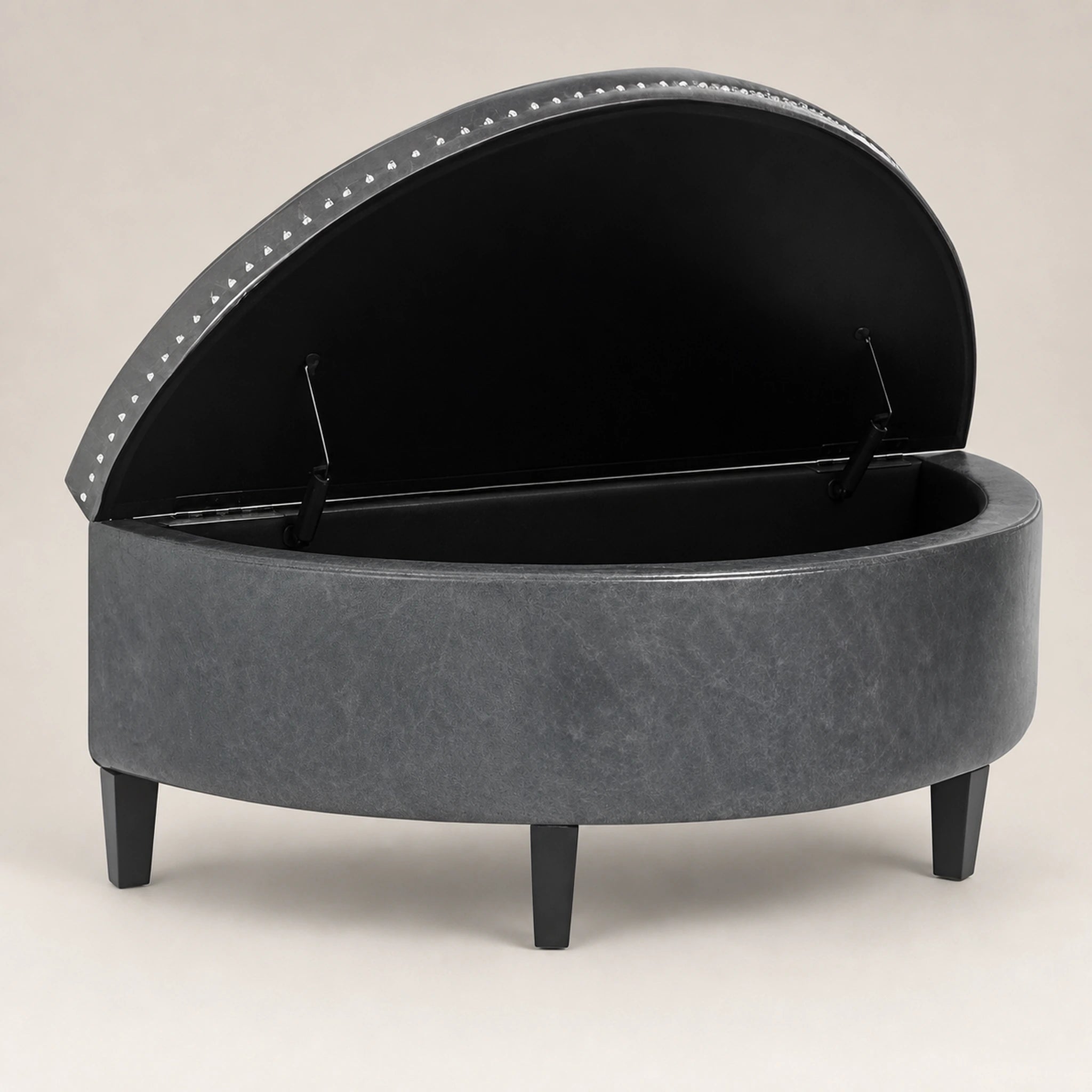 Beringia Grey faux leather 43.5-inch storage ottoman – warm studio front view